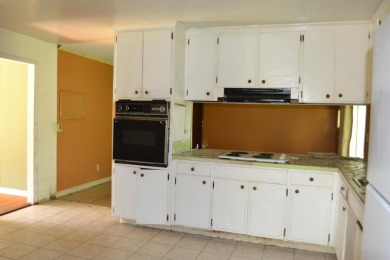 Spacious and full of potential, this 4-bedroom, 2-bathroom home on Jake Gaither Golf Course in Florida - for sale on GolfHomes.com, golf home, golf lot