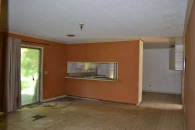 Spacious and full of potential, this 4-bedroom, 2-bathroom home on Jake Gaither Golf Course in Florida - for sale on GolfHomes.com, golf home, golf lot