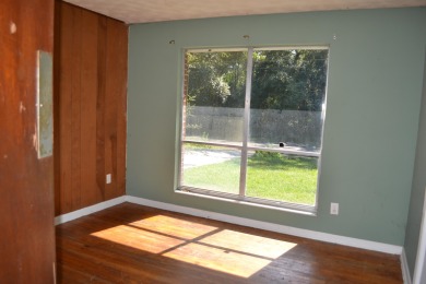 Spacious and full of potential, this 4-bedroom, 2-bathroom home on Jake Gaither Golf Course in Florida - for sale on GolfHomes.com, golf home, golf lot