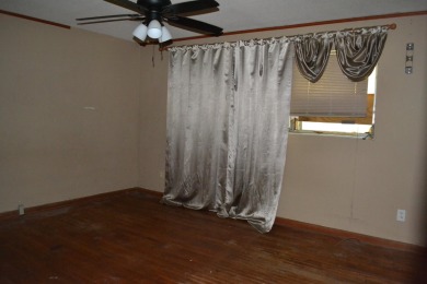 Spacious and full of potential, this 4-bedroom, 2-bathroom home on Jake Gaither Golf Course in Florida - for sale on GolfHomes.com, golf home, golf lot