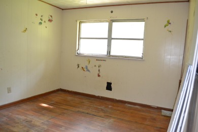 Spacious and full of potential, this 4-bedroom, 2-bathroom home on Jake Gaither Golf Course in Florida - for sale on GolfHomes.com, golf home, golf lot