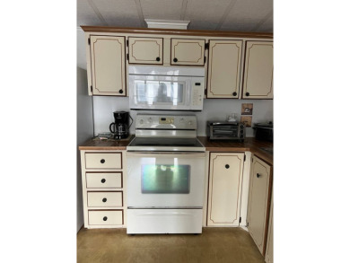 Nicely maintained furnished home on nice lot with no rear on Lake Henry Golf Club in Florida - for sale on GolfHomes.com, golf home, golf lot