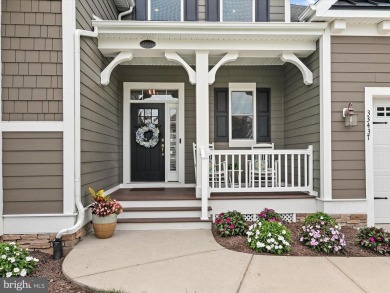 The welcoming covered entry of 33437 Islander Drive invites you on The Peninsula Golf and Country Club in Delaware - for sale on GolfHomes.com, golf home, golf lot
