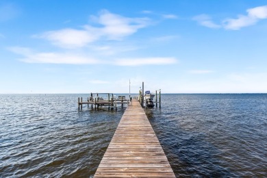 WESTWARD-FACING SINGLE-STORY WATERFRONT ESTATE WITHIN ESTEEMED on Kelly Plantation Golf Club in Florida - for sale on GolfHomes.com, golf home, golf lot