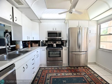 BACK ON THE MARKET WITH NEW KITCHEN WATERFALL COUNTERTOP AND on Wynmoor Golf Course in Florida - for sale on GolfHomes.com, golf home, golf lot