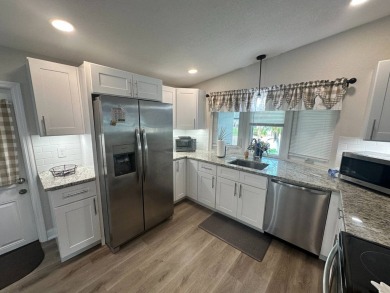 This beautifully remodeled Palm Harbor stucco home is a on Del Tura Golf and Country Club in Florida - for sale on GolfHomes.com, golf home, golf lot