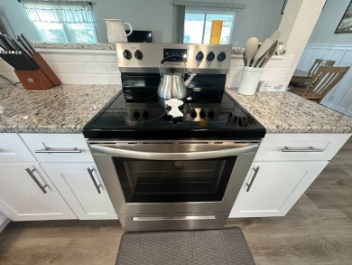 This beautifully remodeled Palm Harbor stucco home is a on Del Tura Golf and Country Club in Florida - for sale on GolfHomes.com, golf home, golf lot