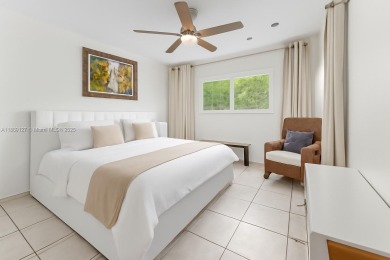 Beautiful light and bright pool home in a gated residential golf on Normandy Shores Golf Course in Florida - for sale on GolfHomes.com, golf home, golf lot