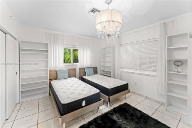 Beautiful light and bright pool home in a gated residential golf on Normandy Shores Golf Course in Florida - for sale on GolfHomes.com, golf home, golf lot