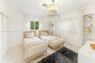 Beautiful light and bright pool home in a gated residential golf on Normandy Shores Golf Course in Florida - for sale on GolfHomes.com, golf home, golf lot