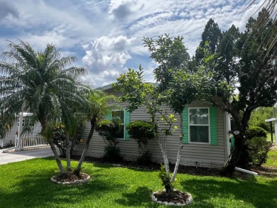 This charming 2-bedroom, 2-bathroom home offers stunning views on Lake Henry Golf Club in Florida - for sale on GolfHomes.com, golf home, golf lot