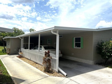 This charming 2-bedroom, 2-bathroom home offers stunning views on Lake Henry Golf Club in Florida - for sale on GolfHomes.com, golf home, golf lot