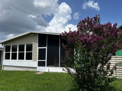 This charming 2-bedroom, 2-bathroom home offers stunning views on Lake Henry Golf Club in Florida - for sale on GolfHomes.com, golf home, golf lot
