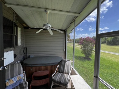 This charming 2-bedroom, 2-bathroom home offers stunning views on Lake Henry Golf Club in Florida - for sale on GolfHomes.com, golf home, golf lot