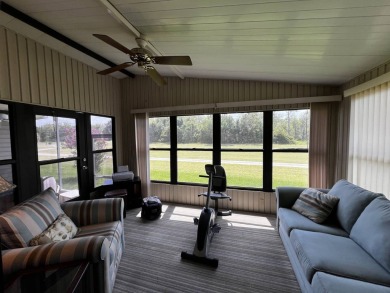 This charming 2-bedroom, 2-bathroom home offers stunning views on Lake Henry Golf Club in Florida - for sale on GolfHomes.com, golf home, golf lot