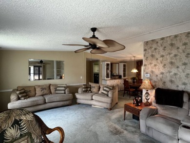 This charming 2-bedroom, 2-bathroom home offers stunning views on Lake Henry Golf Club in Florida - for sale on GolfHomes.com, golf home, golf lot