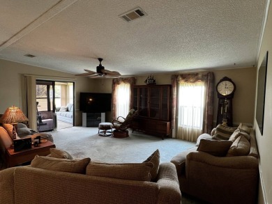 This charming 2-bedroom, 2-bathroom home offers stunning views on Lake Henry Golf Club in Florida - for sale on GolfHomes.com, golf home, golf lot
