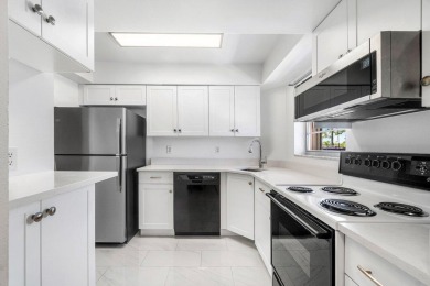 Embrace easy living in this sunlit 2BR/2BA end-unit condo in on The Little Club in Florida - for sale on GolfHomes.com, golf home, golf lot