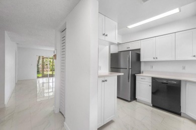 Embrace easy living in this sunlit 2BR/2BA end-unit condo in on The Little Club in Florida - for sale on GolfHomes.com, golf home, golf lot