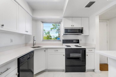 Embrace easy living in this sunlit 2BR/2BA end-unit condo in on The Little Club in Florida - for sale on GolfHomes.com, golf home, golf lot