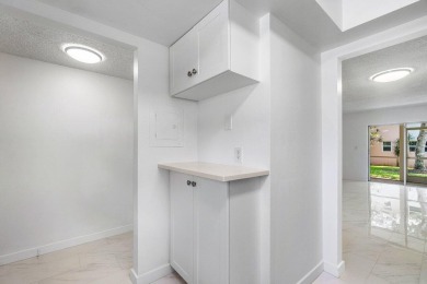 Embrace easy living in this sunlit 2BR/2BA end-unit condo in on The Little Club in Florida - for sale on GolfHomes.com, golf home, golf lot