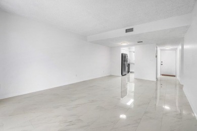 Embrace easy living in this sunlit 2BR/2BA end-unit condo in on The Little Club in Florida - for sale on GolfHomes.com, golf home, golf lot