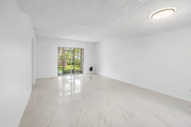 Embrace easy living in this sunlit 2BR/2BA end-unit condo in on The Little Club in Florida - for sale on GolfHomes.com, golf home, golf lot