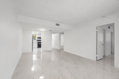 Embrace easy living in this sunlit 2BR/2BA end-unit condo in on The Little Club in Florida - for sale on GolfHomes.com, golf home, golf lot
