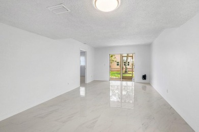 Embrace easy living in this sunlit 2BR/2BA end-unit condo in on The Little Club in Florida - for sale on GolfHomes.com, golf home, golf lot