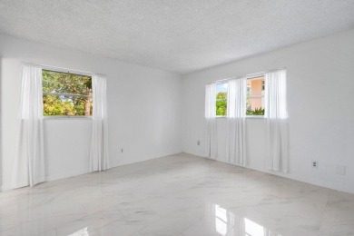 Embrace easy living in this sunlit 2BR/2BA end-unit condo in on The Little Club in Florida - for sale on GolfHomes.com, golf home, golf lot