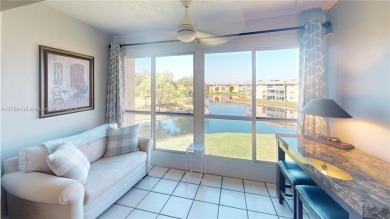 Open the front door to a stunning long lake view!  This is a on Sunrise Lakes Phase III in Florida - for sale on GolfHomes.com, golf home, golf lot