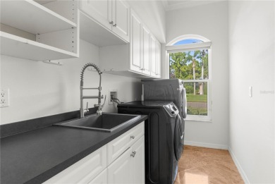 This home is a true SHOWSTOPPER, blending timeless elegance with on Westchase Golf Club in Florida - for sale on GolfHomes.com, golf home, golf lot