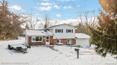 This charming tri-level home is situated on 2.5 acres of on Pine Knob Golf Club - Hawk in Michigan - for sale on GolfHomes.com, golf home, golf lot