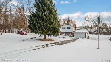 This charming tri-level home is situated on 2.5 acres of on Pine Knob Golf Club - Hawk in Michigan - for sale on GolfHomes.com, golf home, golf lot