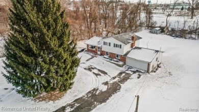 This charming tri-level home is situated on 2.5 acres of on Pine Knob Golf Club - Hawk in Michigan - for sale on GolfHomes.com, golf home, golf lot