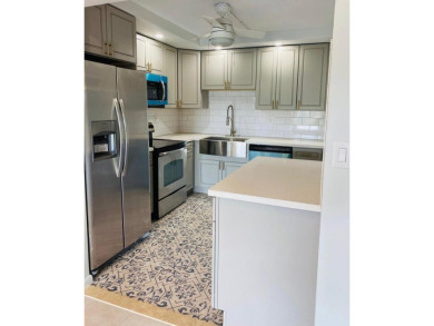 This beautifully remodeled corner unit offers serene views of on Boca Dunes Golf and Country Club in Florida - for sale on GolfHomes.com, golf home, golf lot