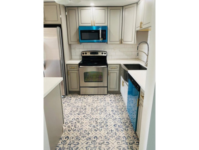 This beautifully remodeled corner unit offers serene views of on Boca Dunes Golf and Country Club in Florida - for sale on GolfHomes.com, golf home, golf lot