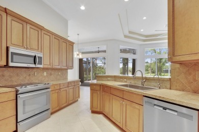 SPECTACULAR GOLF & WATER VIEWS! Nestled within the prestigious on The Legacy Golf and Tennis Club in Florida - for sale on GolfHomes.com, golf home, golf lot