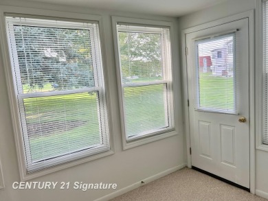 Enjoy easy living in this 2-bedroom, 2-full-bath condo perfectly on Swan Valley Golf Club in Michigan - for sale on GolfHomes.com, golf home, golf lot