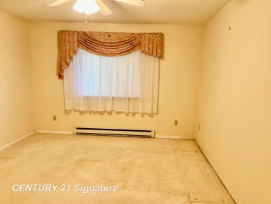 Enjoy easy living in this 2-bedroom, 2-full-bath condo perfectly on Swan Valley Golf Club in Michigan - for sale on GolfHomes.com, golf home, golf lot