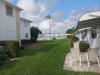 Fall in love with this 2Br/2Ba corner villa is ideally located on Leisureville Community Golf Course in Florida - for sale on GolfHomes.com, golf home, golf lot