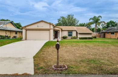 AFFORDABLE HOME IN THE HEART OF SPRING HILL ~ Welcome to this on Oak Hills Country Club in Florida - for sale on GolfHomes.com, golf home, golf lot