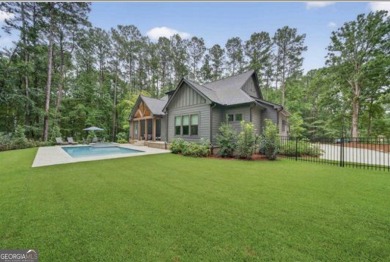 Experience elegance and privacy in this immaculate 4-bedroom, 3 on Harbor Club Golf and Country Club in Georgia - for sale on GolfHomes.com, golf home, golf lot