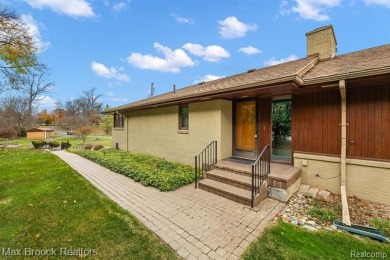 Experience the charm and tranquility of lakefront living in this on Forest Lake Country Club in Michigan - for sale on GolfHomes.com, golf home, golf lot