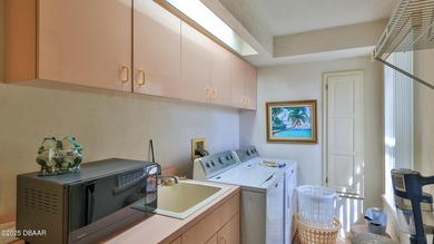 Contemporary, two story brick home has elegance and style on Spruce Creek Golf Club in Florida - for sale on GolfHomes.com, golf home, golf lot