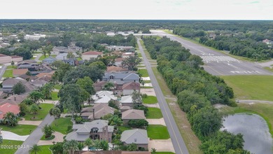Contemporary, two story brick home has elegance and style on Spruce Creek Golf Club in Florida - for sale on GolfHomes.com, golf home, golf lot