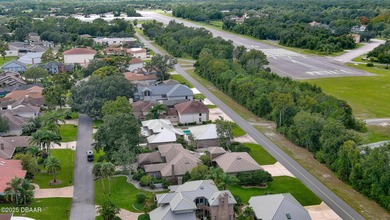 Contemporary, two story brick home has elegance and style on Spruce Creek Golf Club in Florida - for sale on GolfHomes.com, golf home, golf lot