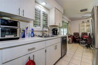 Nestled in the heart of Palm Harbor's sought-after Highland on Highland Lakes Executive Golf Course in Florida - for sale on GolfHomes.com, golf home, golf lot