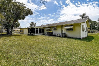 Nestled in the heart of Palm Harbor's sought-after Highland on Highland Lakes Executive Golf Course in Florida - for sale on GolfHomes.com, golf home, golf lot