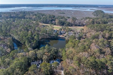 Enjoy the incredible sunset views of a large lagoon and bird on Callawassie Island Club in South Carolina - for sale on GolfHomes.com, golf home, golf lot